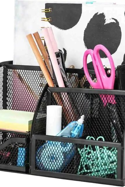 A black mesh desk organizer filled with colorful office stationery and scissors.