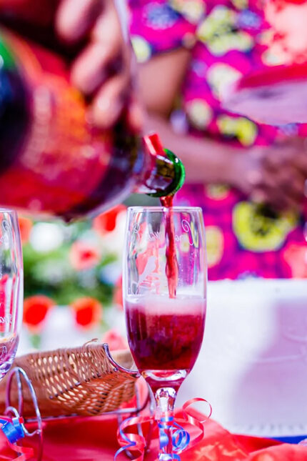 Pouring sparkling red champagne into a flute glass for a private party toast in Crawley.