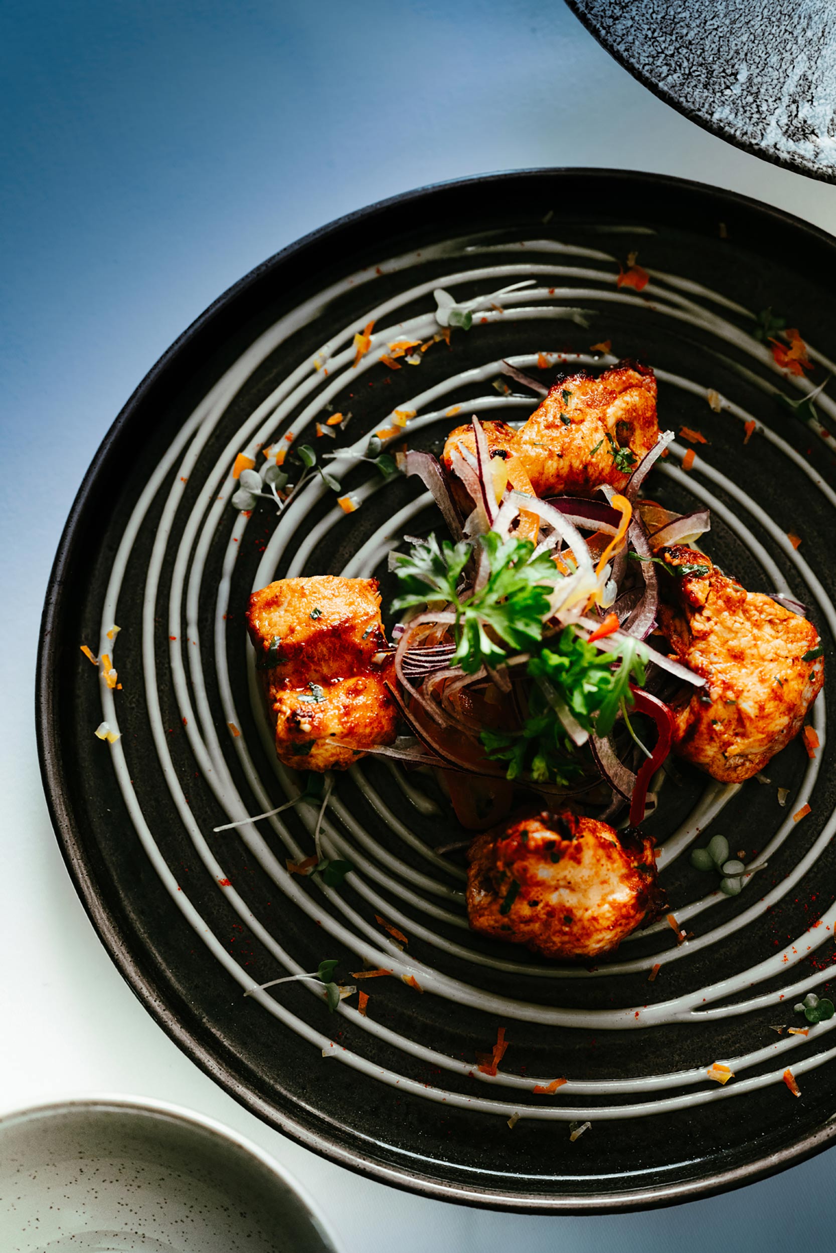 Sizzling tandoori chicken starters prepared for premium Indian delivery in Crawley