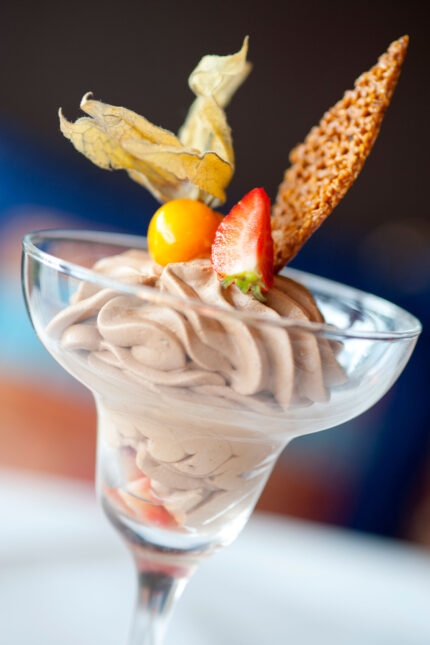 reamy chocolate mousse dessert topped with a strawberry and physalis berry at Zari Crawley.