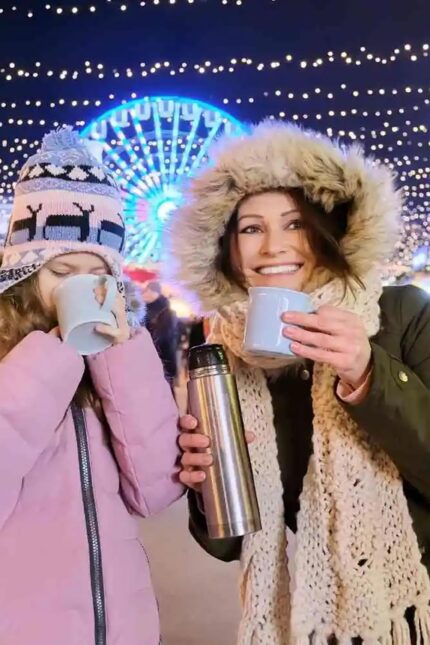 A cozy winter holiday celebration featuring illuminated fairground rides in West Sussex.