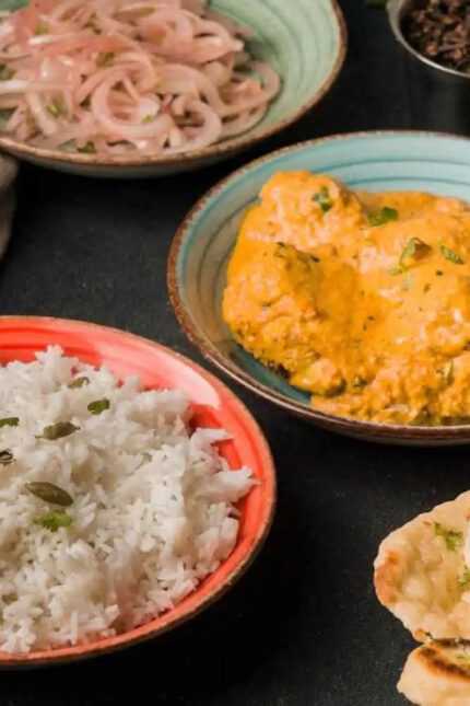 Aromatic South Indian chicken curry served with a bowl of fluffy basmati rice at Zari.