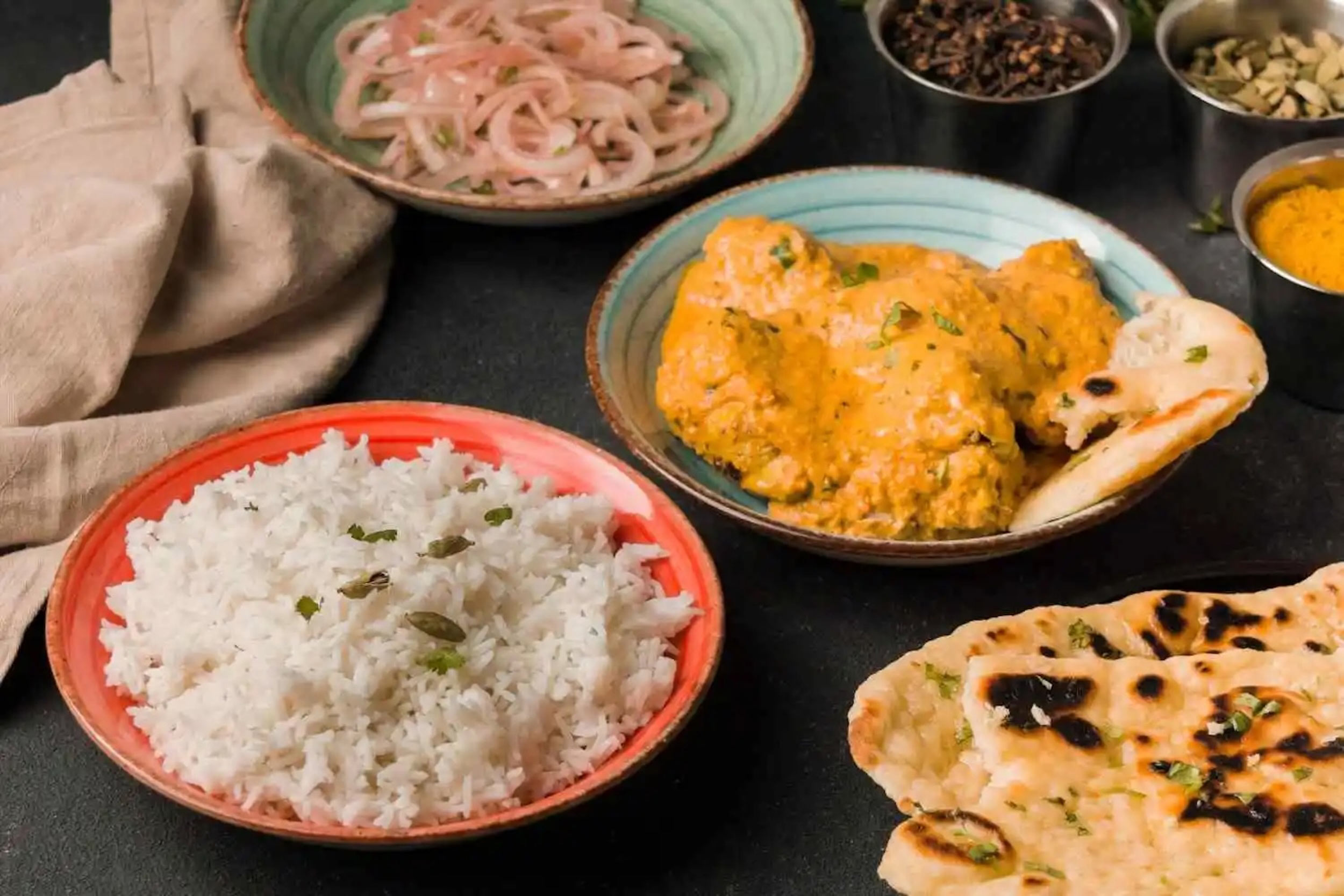 Aromatic South Indian chicken curry served with a bowl of fluffy basmati rice at Zari.
