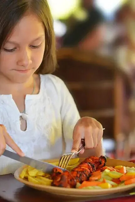 Families enjoying a summer holiday dinner over the kids eat free deal in Crawley.