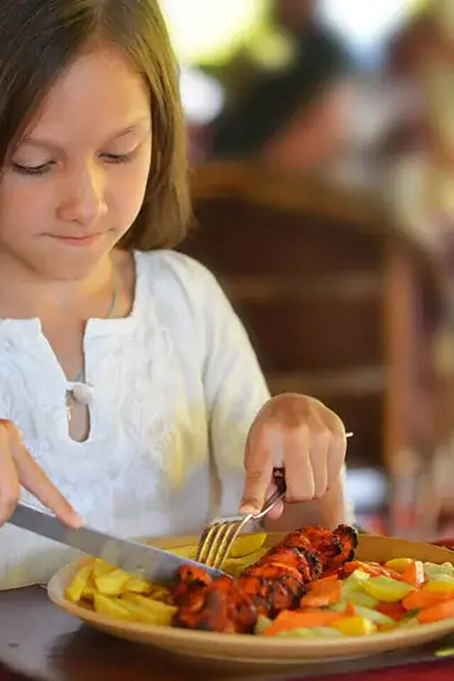 Families enjoying a summer holiday dinner over the kids eat free deal in Crawley.