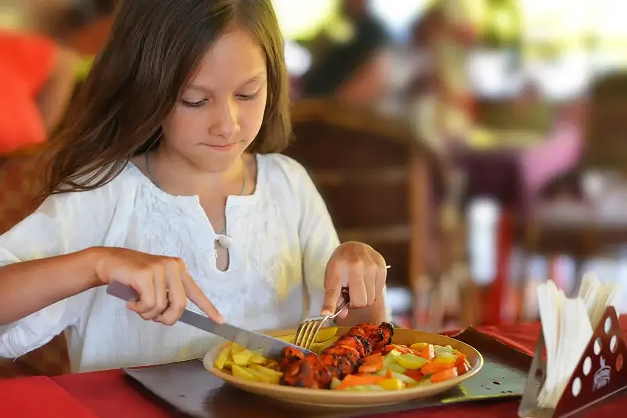 Families enjoying a summer holiday dinner over the kids eat free deal in Crawley.