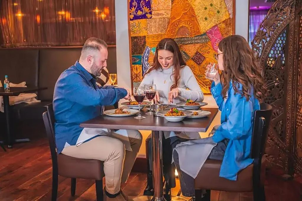 Guests enjoying a healthy, garlic-infused Indian dinner at Zari Restaurant in Crawley.