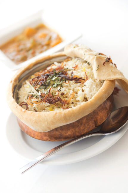 Authentic pot biryani topped with fried onions for a Father's Day family feast in Crawley.