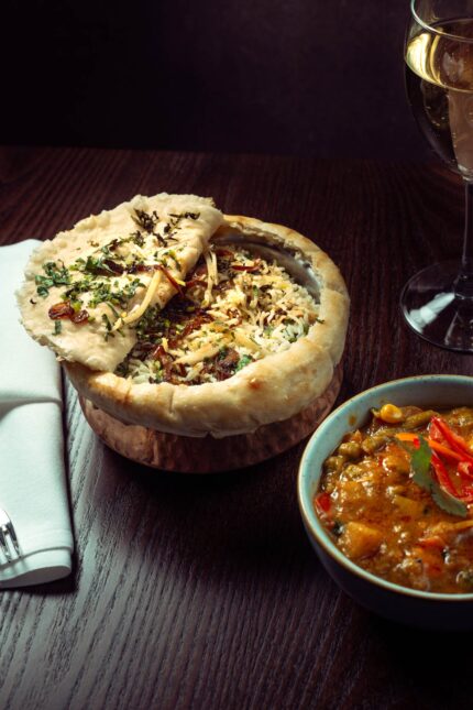 Gourmet pot biryani and curry spread for corporate event catering at Zari Crawley.