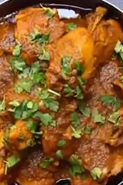Spicy Rajasthani Laal Maas red mutton curry garnished with Kashmiri chillies at Zari in Crawley.