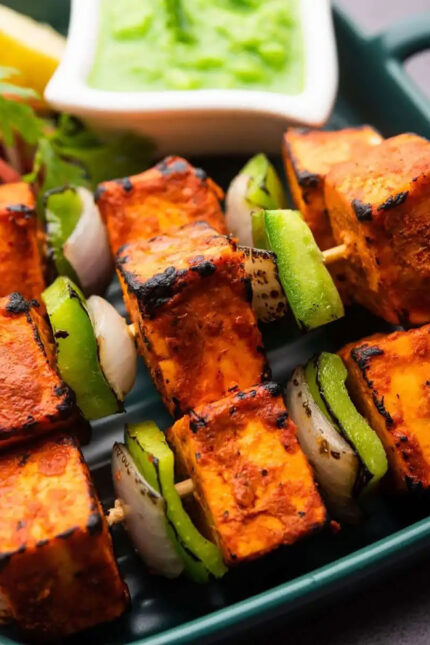 Sizzling tandoori paneer tikka skewers served with green chutney at Zari Crawley.