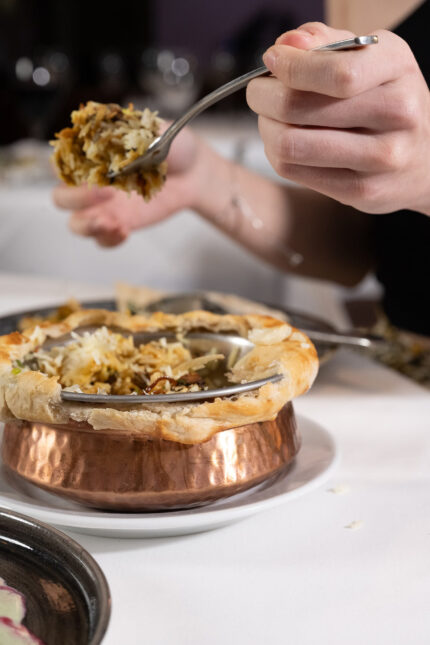 Aromatic rice biryani from a copper pot sealed with a pastry crust at Zari.