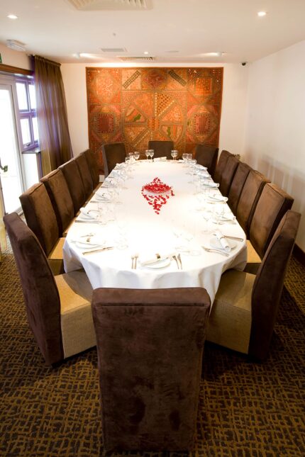 An elegant long banquet table set for full venue hire and private group dining at Zari Crawley.