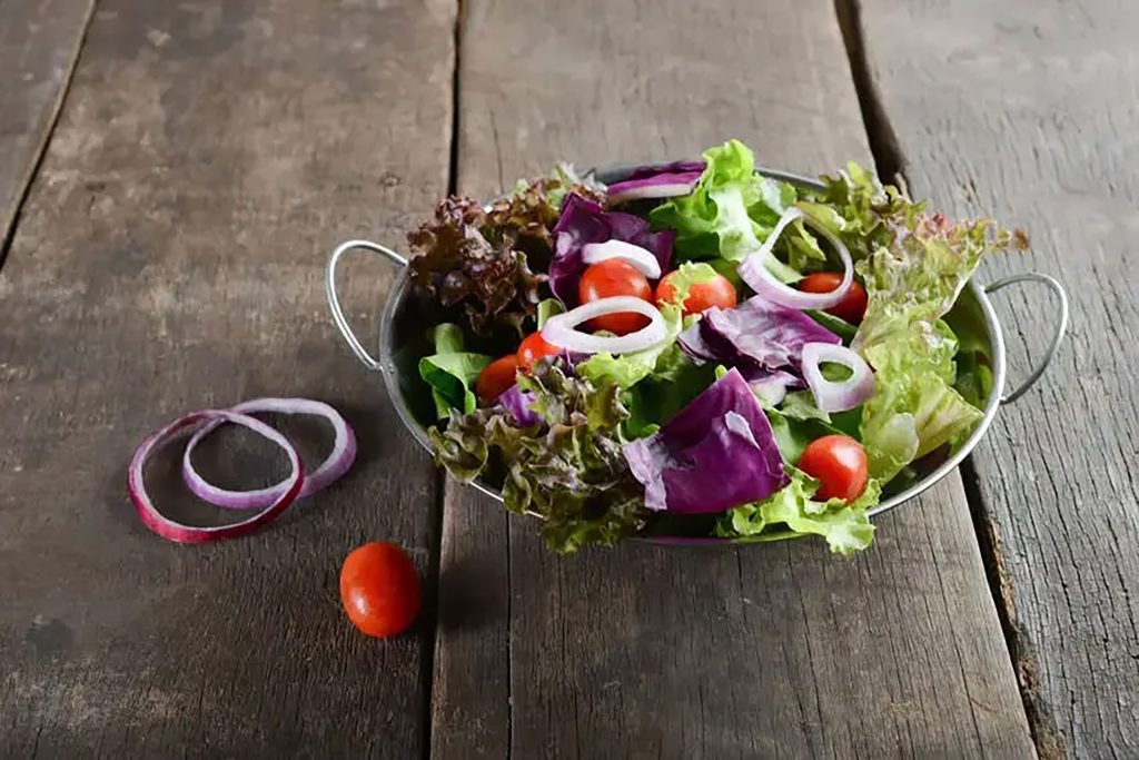 Crisp mixed leaf and purple cabbage salad bowl served fresh at Zari Restaurant in Crawley.