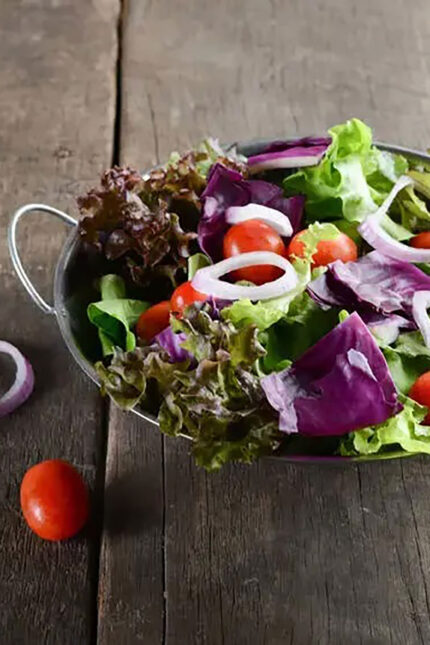 Crisp mixed leaf and purple cabbage salad bowl served fresh at Zari Restaurant in Crawley.