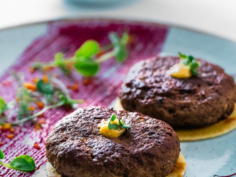 Gourmet Indian kebabs on a blue plate, served at a fine dining restaurant near Horsham.