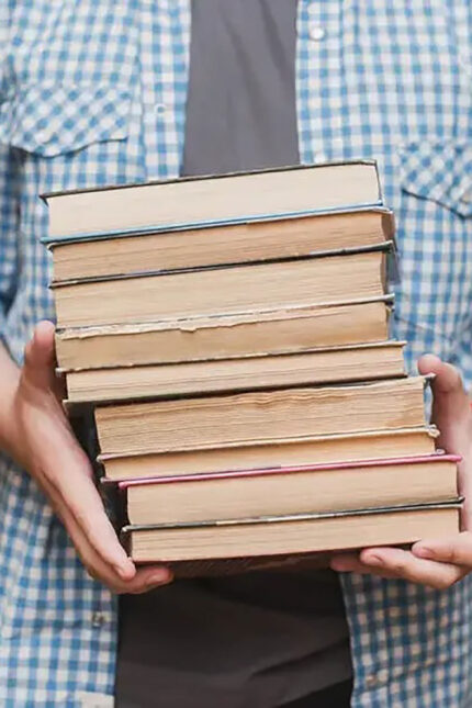 Stack of pre-loved books collected for a community literacy campaign in West Sussex.