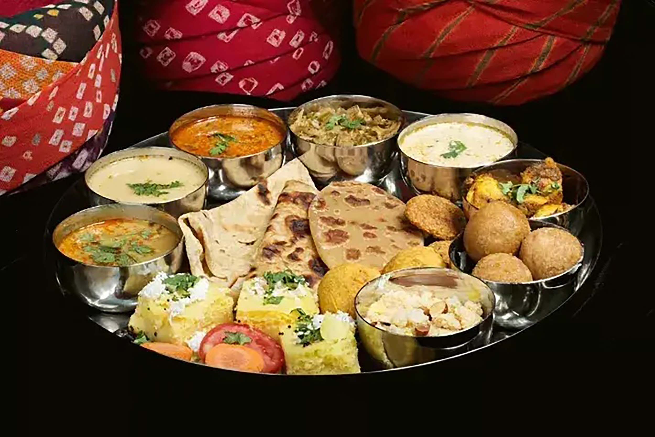 Traditional Rajasthani thali platter with curries and flatbreads at Zari Crawley.