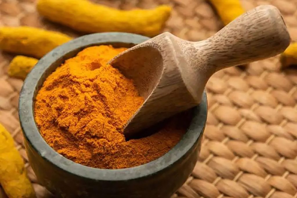 Aromatic ground turmeric powder and colorful spices at Zari Indian restaurant in Crawley.