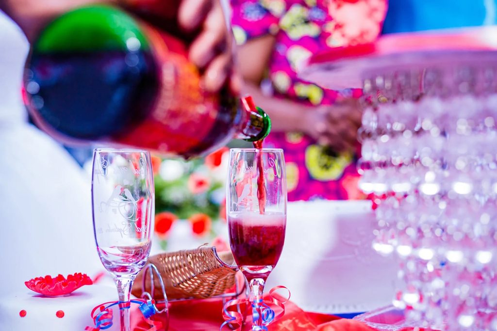 Pouring sparkling red champagne into a flute glass for a private party toast in Crawley.