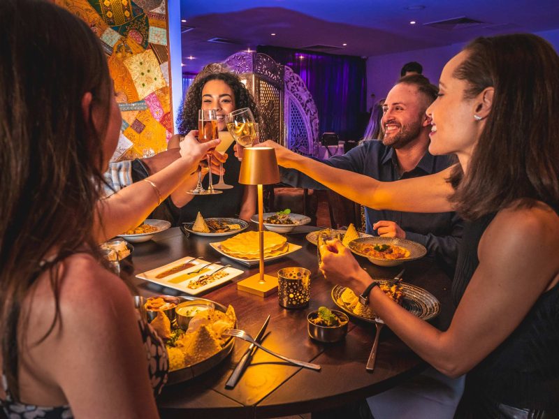 Guests raising glasses at a private dining celebration at Zari Restaurant.