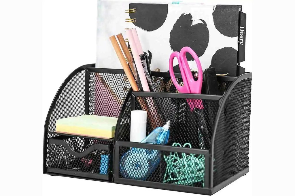 A black mesh desk organizer filled with colorful office stationery and scissors.