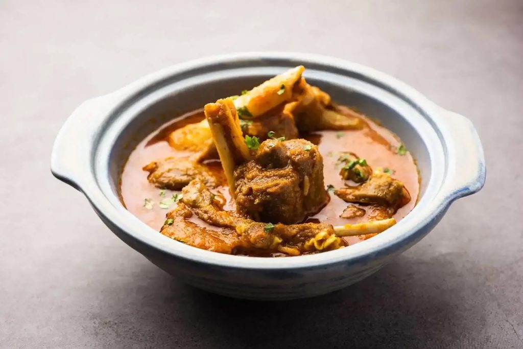 Tender cuts of bone-in mutton curry showcasing authentic regional Bengali spices.