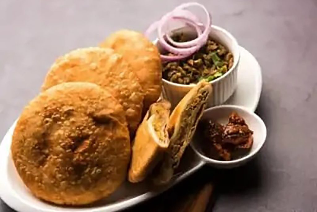 Golden crispy onion kachori pastry stuffed with caramelized onions and aromatic spices.
