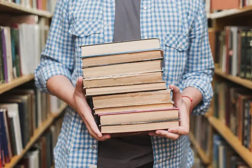 Stack of pre-loved books collected for a community literacy campaign in West Sussex.